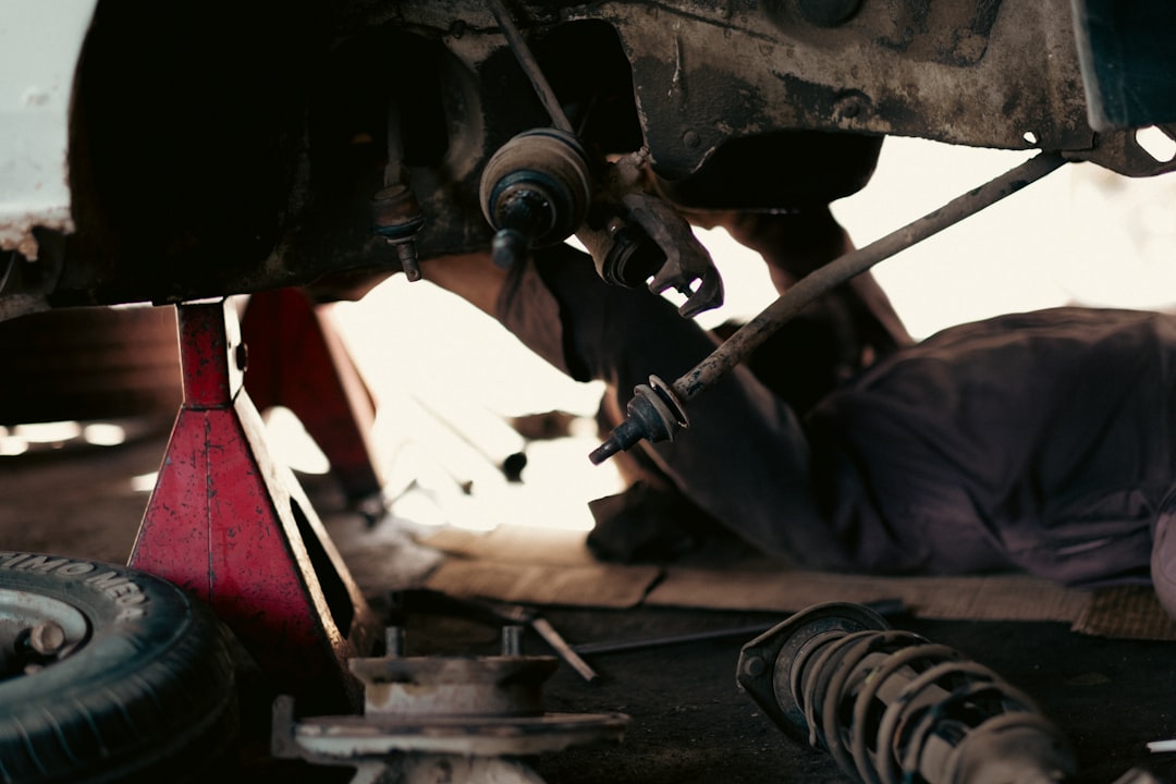 Mobile mechanic working under the hood of a car in a Bowling Green, Kentucky driveway